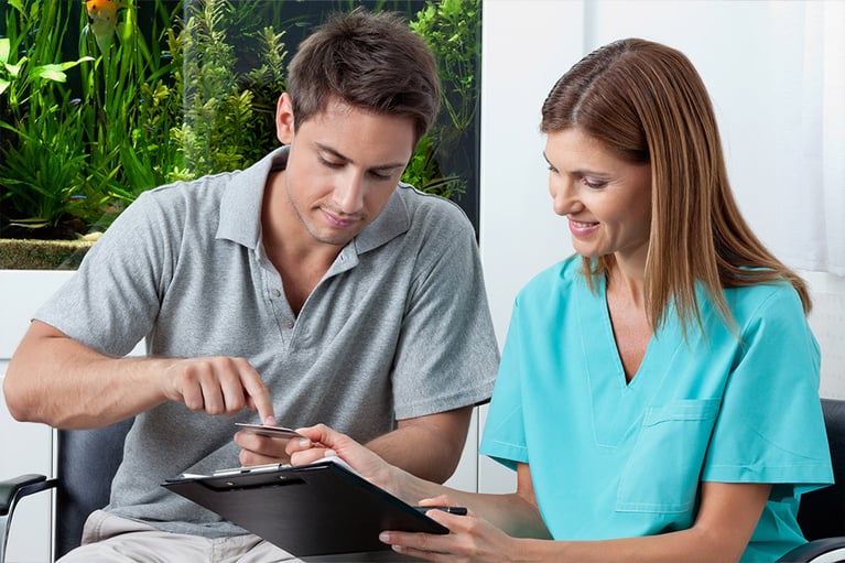 Man Paying Through Credit Card To Dentist