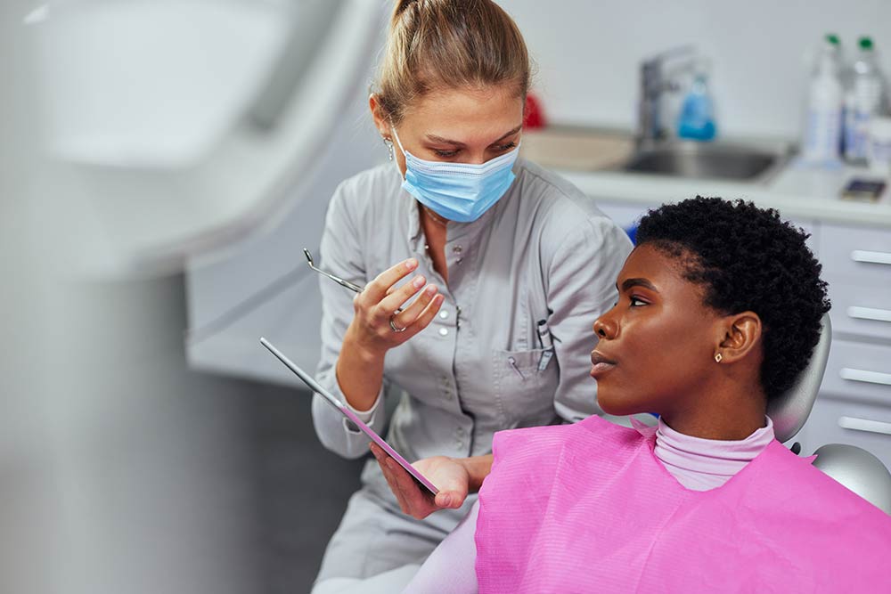 Dental hygenist working with patient