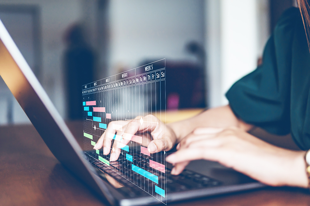 Woman typing on computer with illustration of scheduling chart