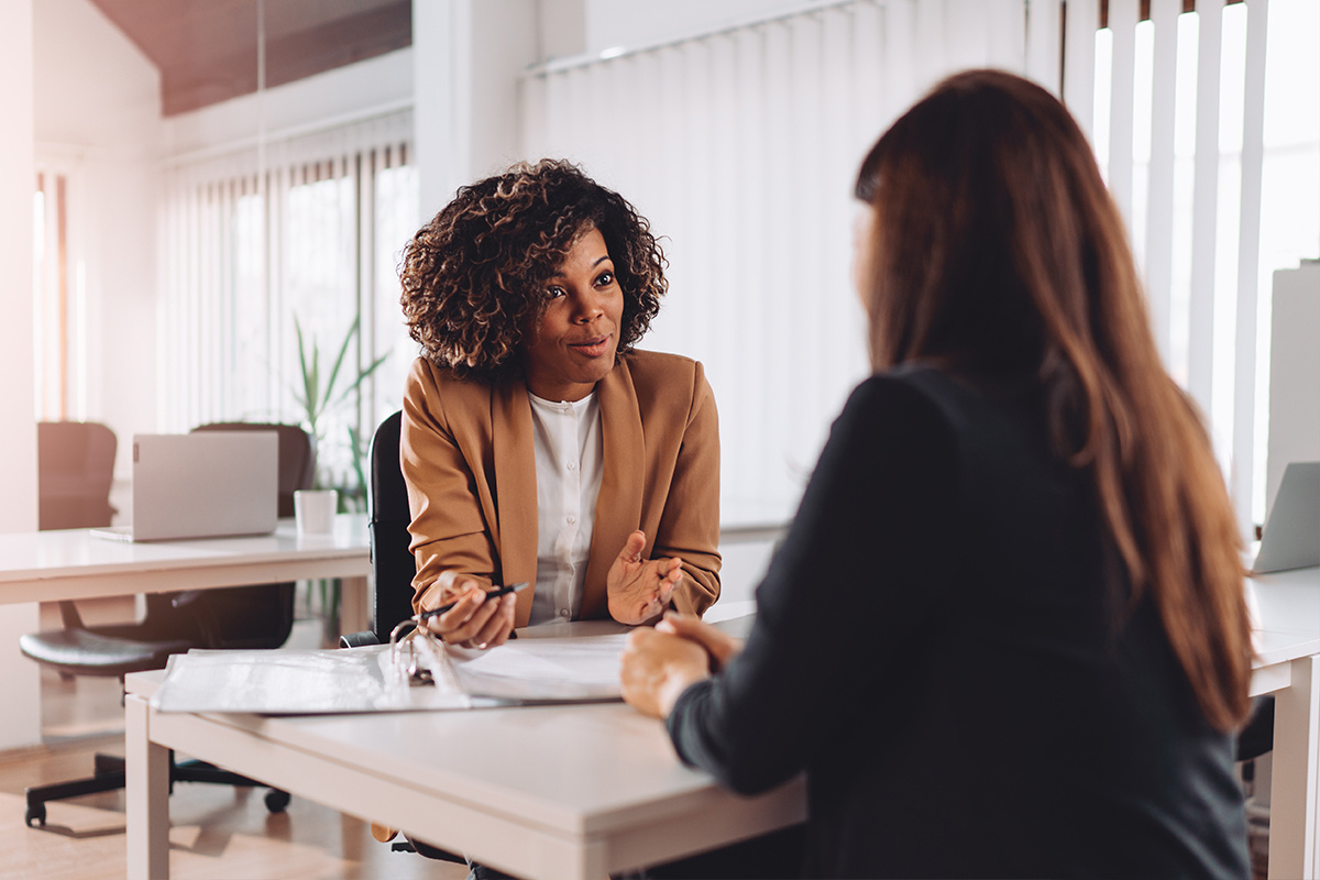 Young woman conducting interview for other young woman