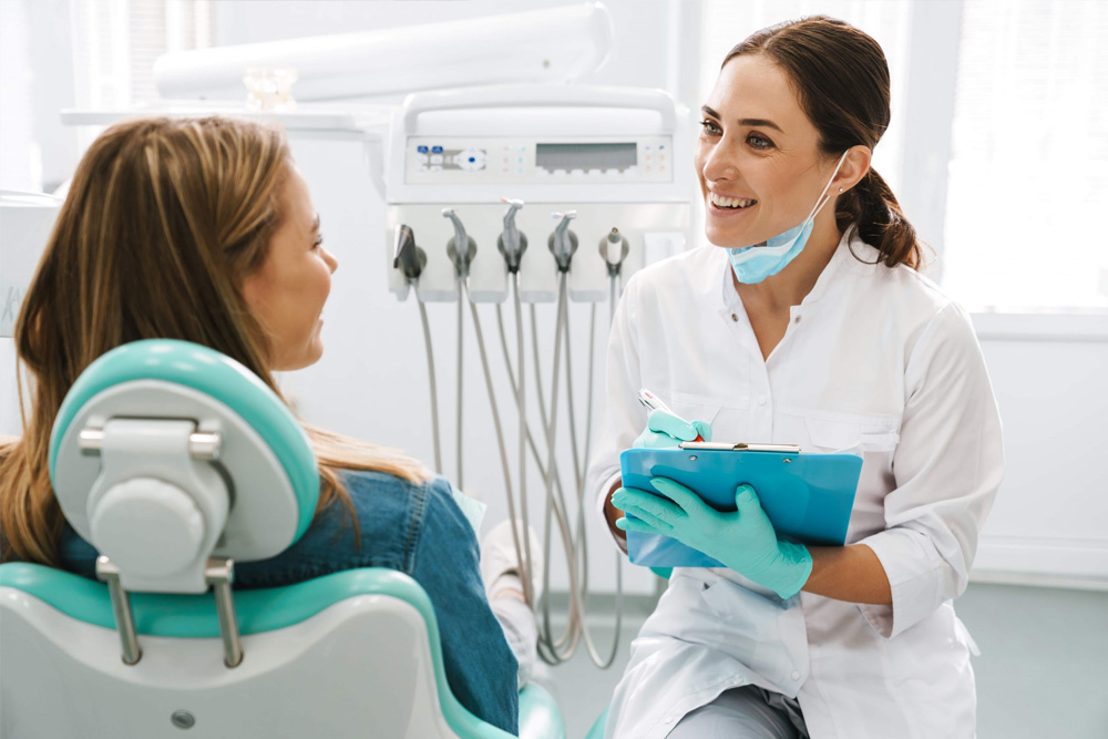 smiling female dentist going over results with patient