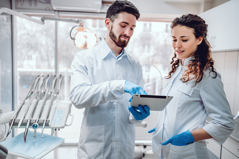 Two colleagues looking at screen of the tablet.