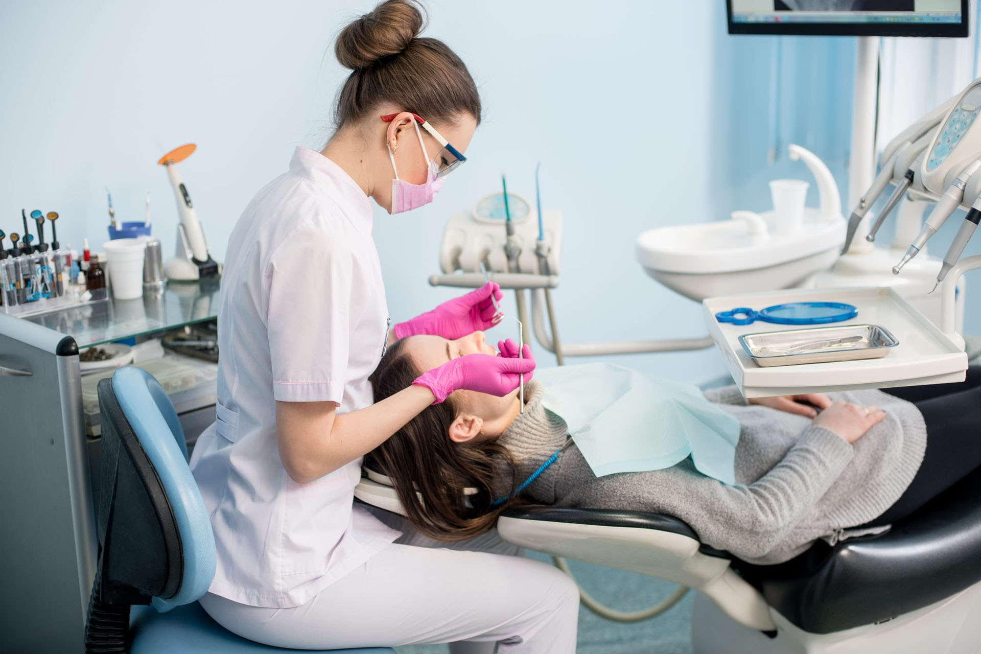 dental hygienist cleaning a woman's teeth