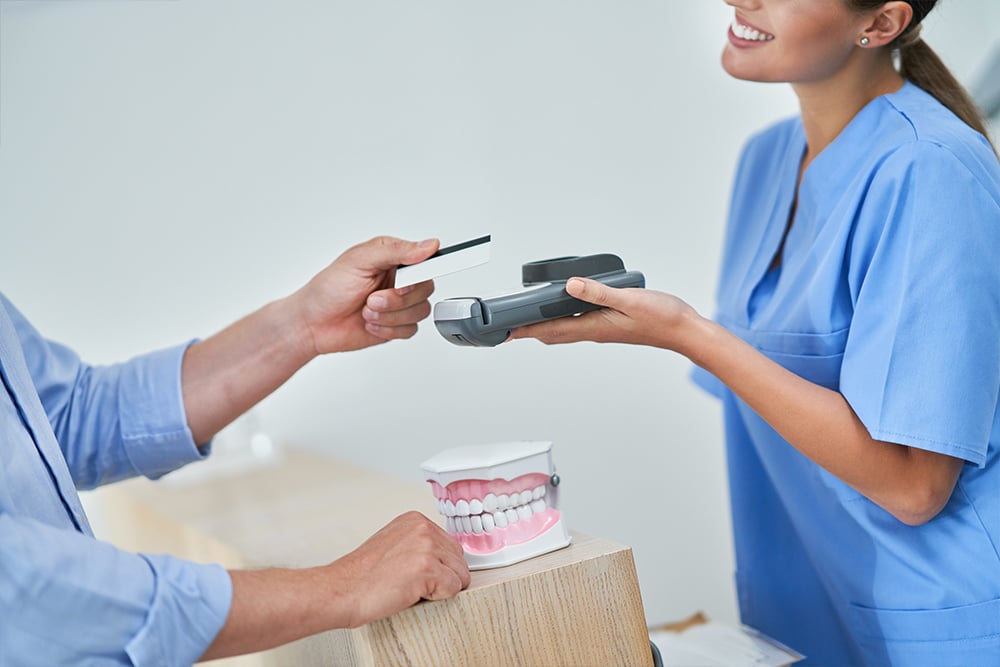 Patient paying for dental visit in clinic